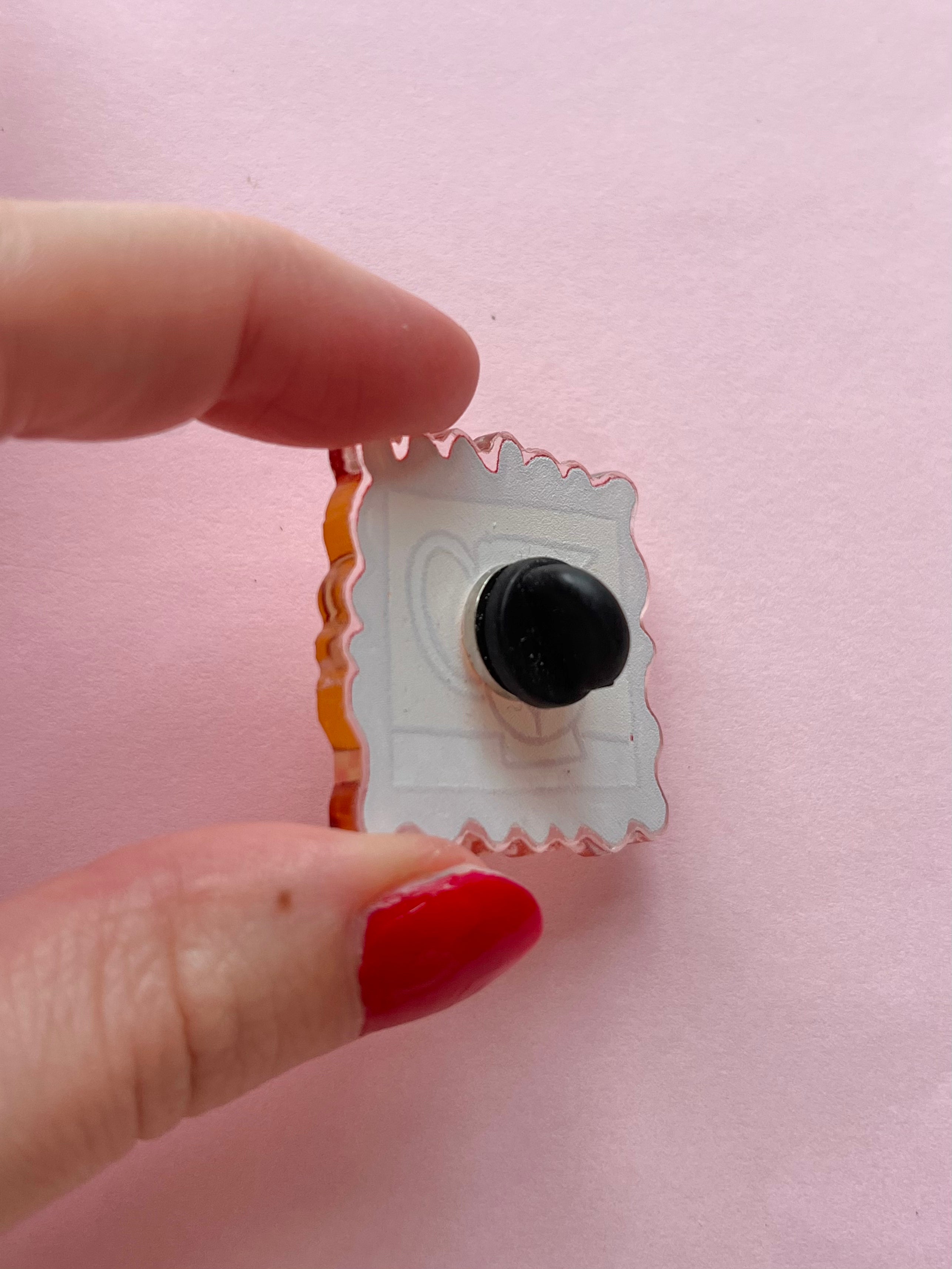 Framed flower pin badge